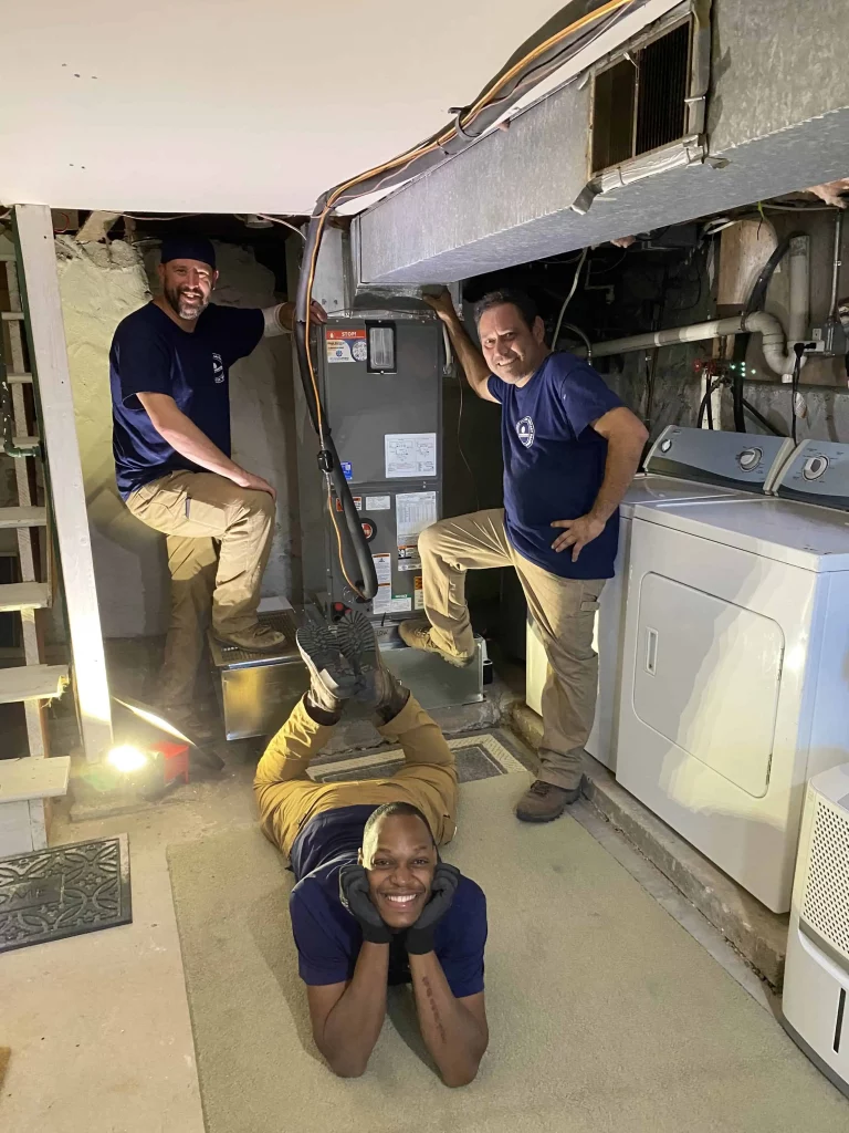 The PlumbPRO team after installing a heat pump and air handler