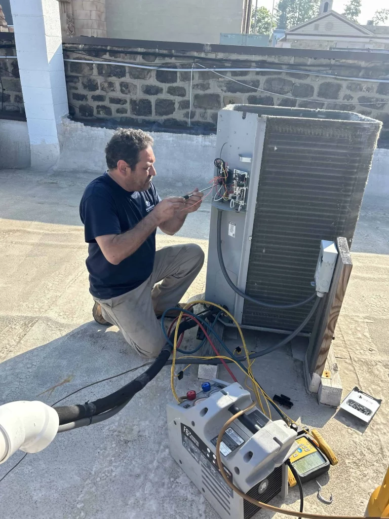 PlumbPRO Services tech installing an air conditioning unit