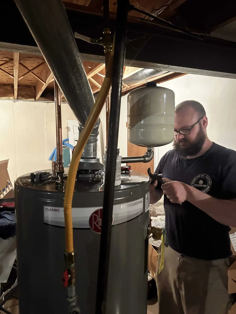 PlumbPRO Services technician repairs water heater